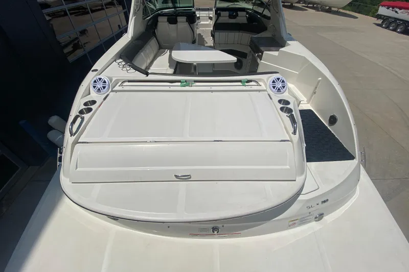 Slide: The Image of 2018 Sea Ray SLX 350 boat with spacious deck and seating area. - 11
