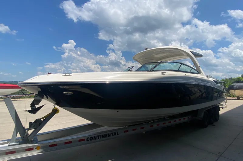 Slide: The Image of 2018 Sea Ray SLX 350 boat on trailer under a partly cloudy sky. - 6