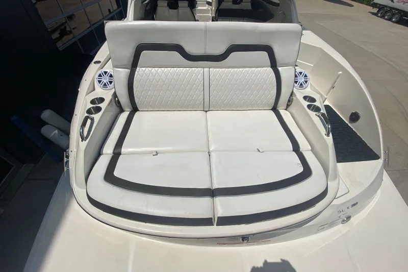 Slide: The Image of 2018 Sea Ray SLX 350 boat with white cushioned seating and cup holders. - 9