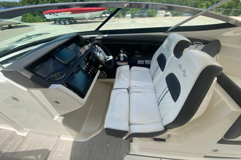 Slide: The Image of 2018 Sea Ray SLX 350 cockpit with dual white seats and modern dashboard. - 46