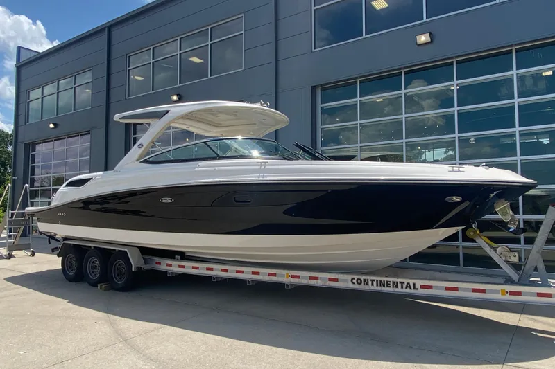 Slide: The Image of 2018 Sea Ray SLX 350 boat on trailer outside modern building. - 2