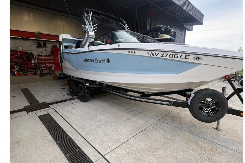 The Image of 2022 MasterCraft X24 boat on trailer in garage setting. - 0