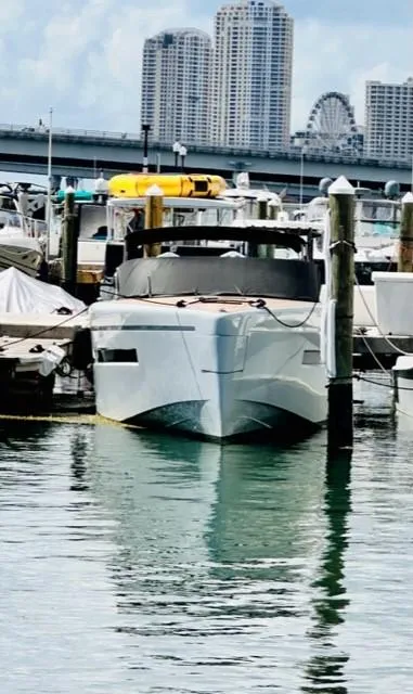 Slide: The Image of Luxury Canard Yachts eMotion HYBRID 2018 docked in marina with cityscape backdrop. - 8