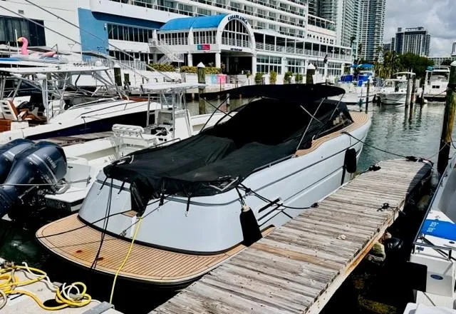 Slide: The Image of 2018 Canard Yachts eMotion HYBRID docked at a marina, covered and ready for use. - 9
