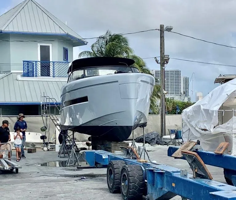 Slide: The Image of 2018 Canard Yachts eMotion HYBRID on trailer at marina, with people nearby. - 28