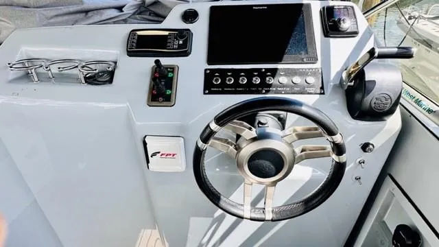 Slide: The Image of Steering console of 2018 Canard Yachts eMotion HYBRID with modern controls and navigation display. - 14