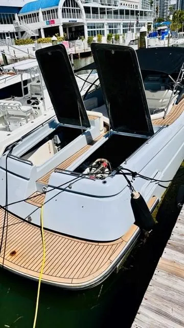 Slide: The Image of 2018 Canard Yachts eMotion HYBRID docked, showcasing open compartments and sleek design. - 12