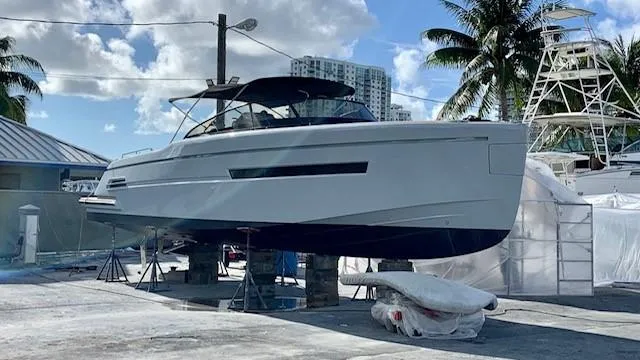 Slide: The Image of 2018 Canard Yachts eMotion HYBRID on dry dock, surrounded by palm trees and clear skies. - 30