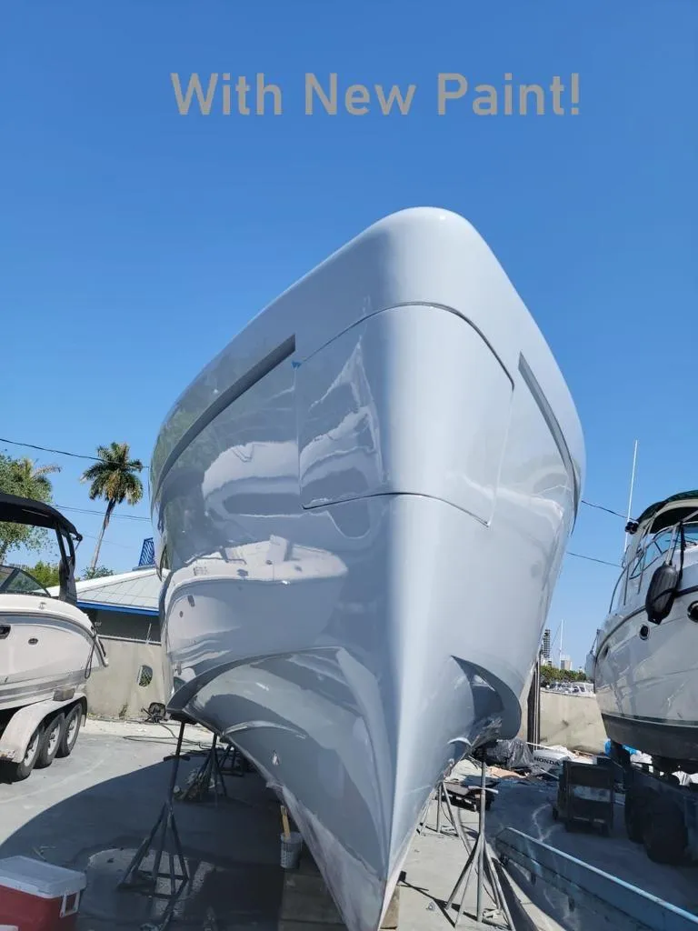 Slide: The Image of 2018 Canard Yachts eMotion HYBRID with fresh paint, docked under clear blue sky. - 32