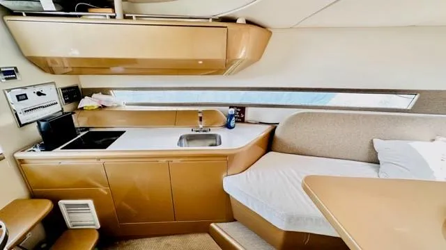 Slide: The Image of Interior of 2018 Canard Yachts eMotion HYBRID, featuring a compact kitchen and seating area. - 22