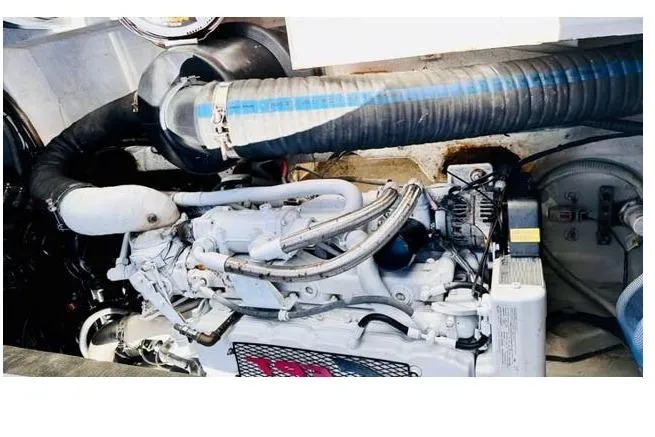 Slide: The Image of Engine compartment of 2018 Canard Yachts eMotion HYBRID, showcasing mechanical components and hoses. - 36