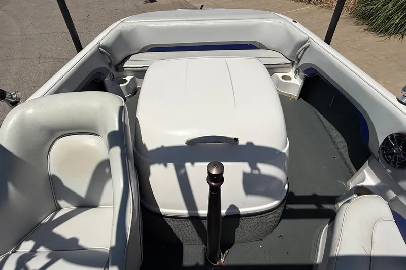 Slide: The Image of 2001 Moomba Outback boat interior with white seating and central engine cover. - 10