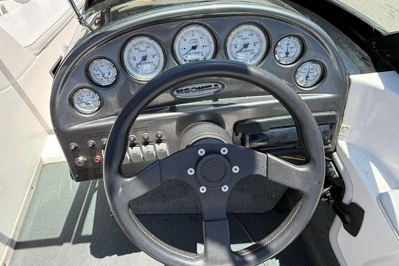 Slide: The Image of 2001 Moomba Outback dashboard with steering wheel and gauges. - 8
