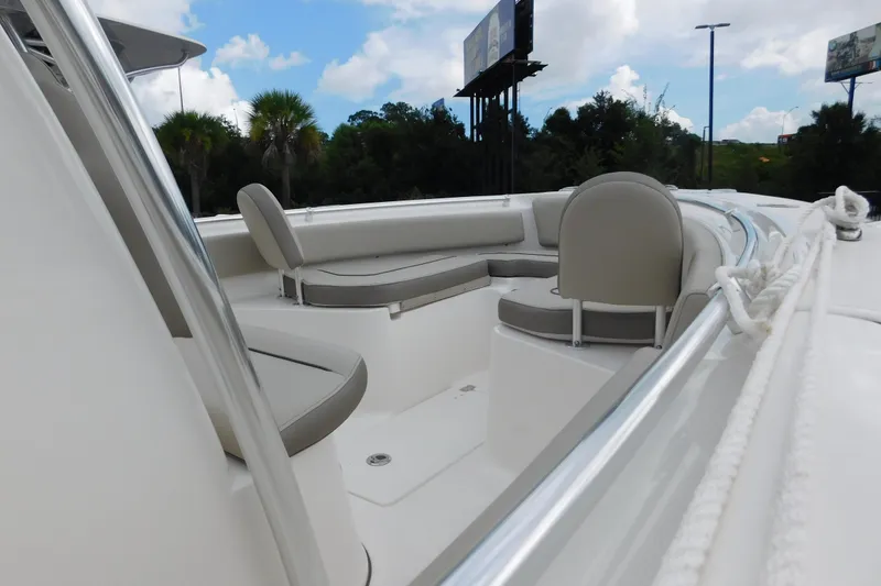 Slide: The Image of 2024 Key West 239 FS boat interior with cushioned seating and sleek design. - 10