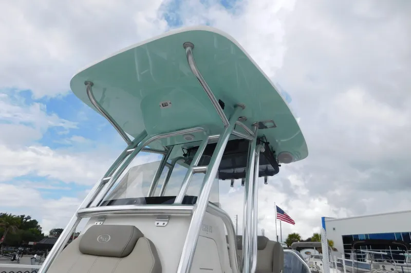 Slide: The Image of 2024 Key West 239 FS boat with T-top and American flag in background. - 13
