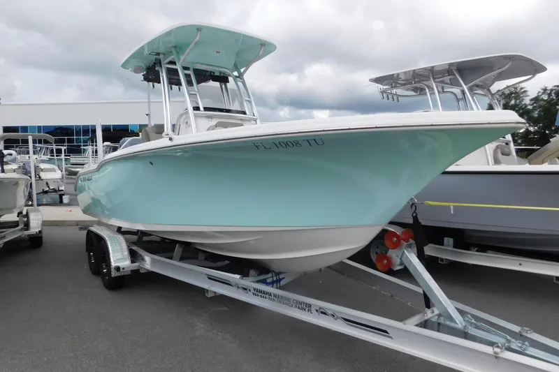 The Image of 2024 Key West 239 FS boat on trailer, displayed outdoors under cloudy sky. - 0