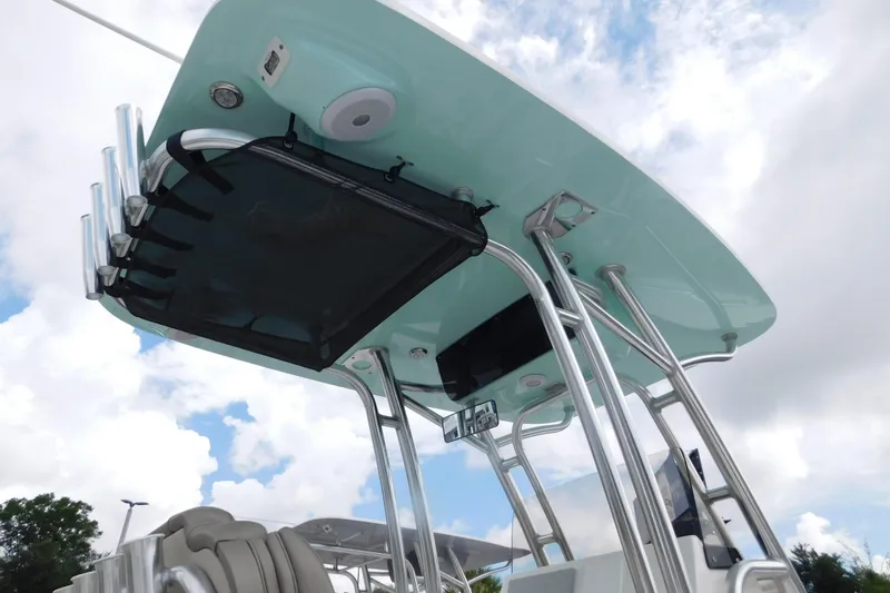 Slide: The Image of 2024 Key West 239 FS boat with sleek T-top and rod holders against a cloudy sky. - 8