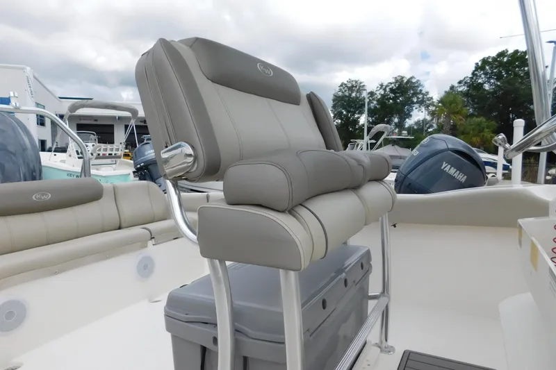 Slide: The Image of 2024 Key West 239 FS boat interior with cushioned seating and Yamaha engine. - 9