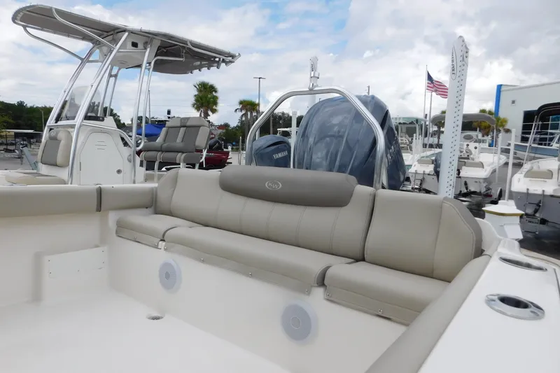 Slide: The Image of 2024 Key West 239 FS boat interior with seating and console, docked at marina. - 14