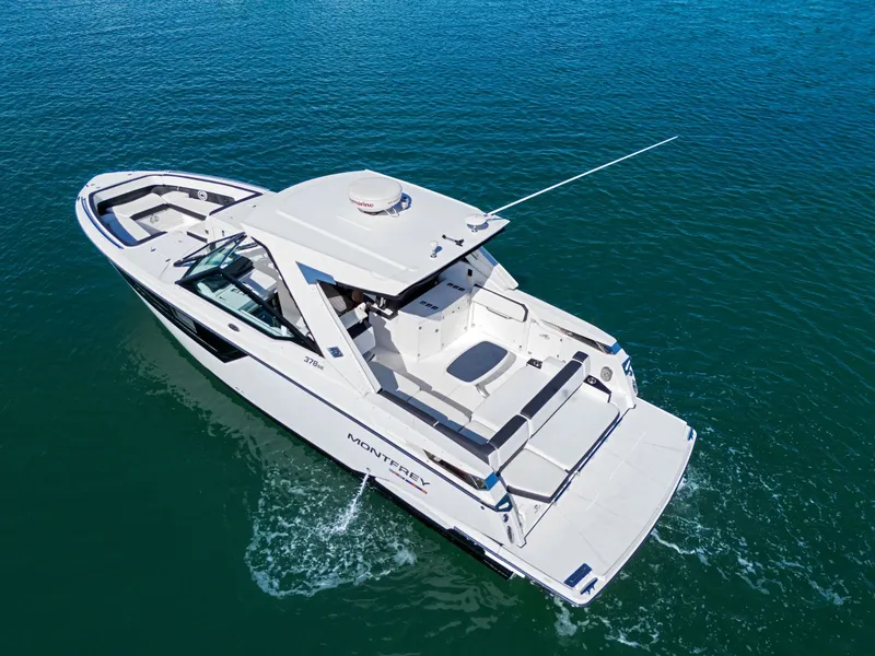 Slide: The Image of A white 2017 Monterey 378SE Super Express boat cruising on calm water. - 9