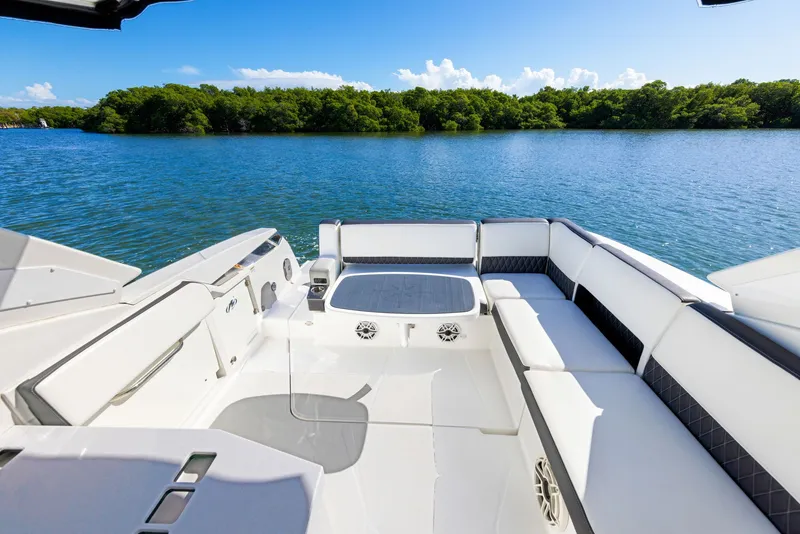Slide: The Image of The image shows the spacious aft deck of a 2017 Monterey 378SE Super Express boat on calm water. - 17