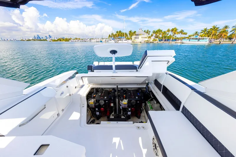 Slide: The Image of The image shows the cockpit of a 2017 Monterey 378SE Super Express. It's on the water near a tropical shoreline. - 31