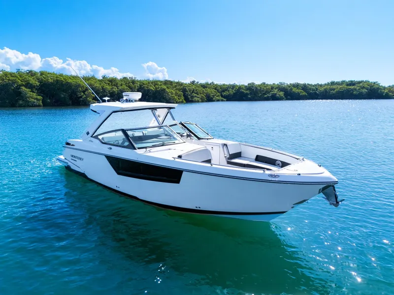 The Image of A white 2017 Monterey 378SE Super Express boat on calm water, surrounded by trees. - 0