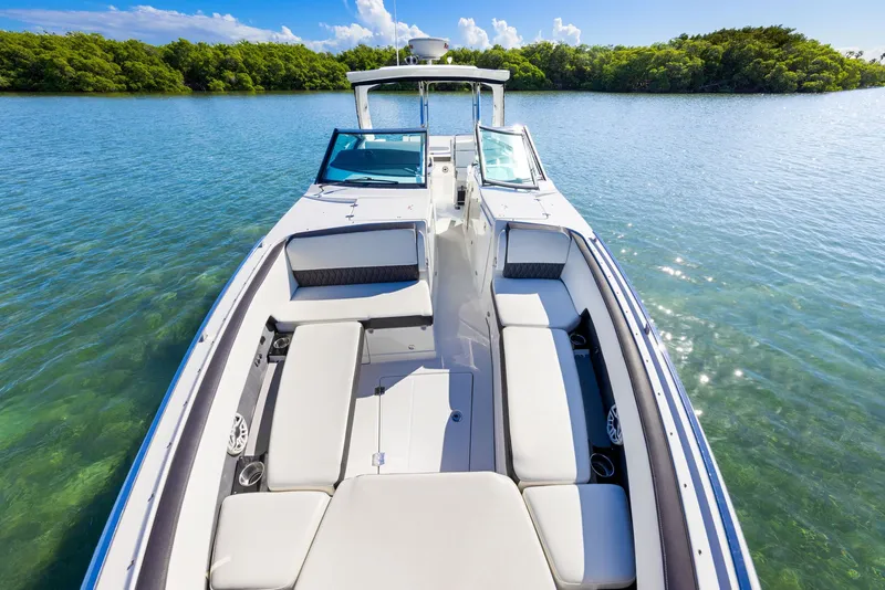 Slide: The Image of The boat is a 2017 Monterey 378SE Super Express, on calm water with a green shoreline. - 20