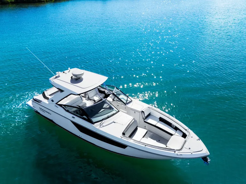 Slide: The Image of A white boat floating on clear blue water, featuring a spacious deck and modern lines. - 7