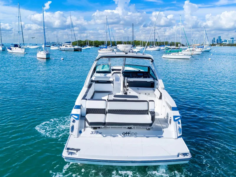 Slide: The Image of A 2017 Monterey 378SE Super Express on calm water, surrounded by other boats. - 5