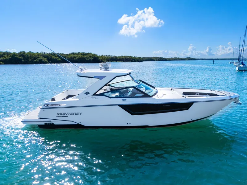 Slide: The Image of A white 2017 Monterey 378SE Super Express boat on calm water. - 6