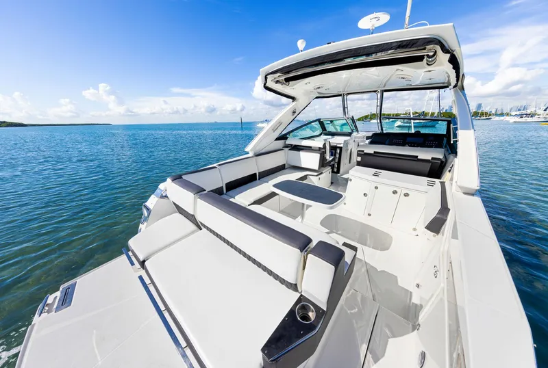 Slide: The Image of The image shows a luxurious boat with a spacious deck and seating area on calm water. - 19