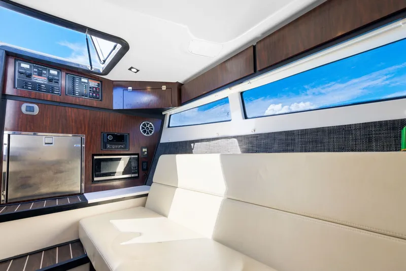 Slide: The Image of Interior of a 2017 Monterey 378SE Super Express with seating and control panel. - 25