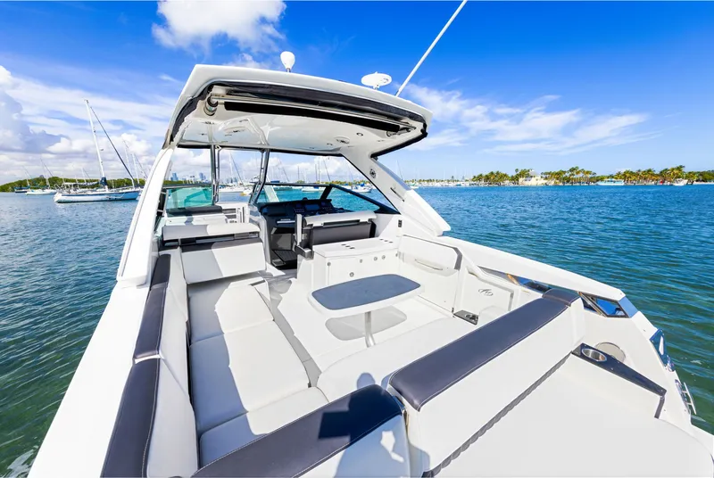 Slide: The Image of The image shows a luxurious boat with a spacious deck and seating area on calm water. - 18