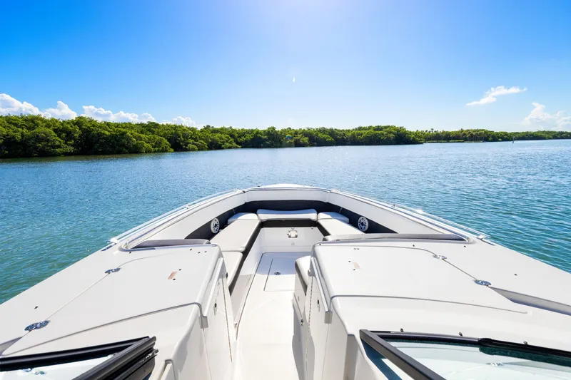 Slide: The Image of The boat features an open bow with seating, cruising on calm water. - 10