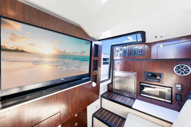 Slide: The Image of Interior of a 2017 Monterey 378SE Super Express with wood paneling and a large TV. - 27