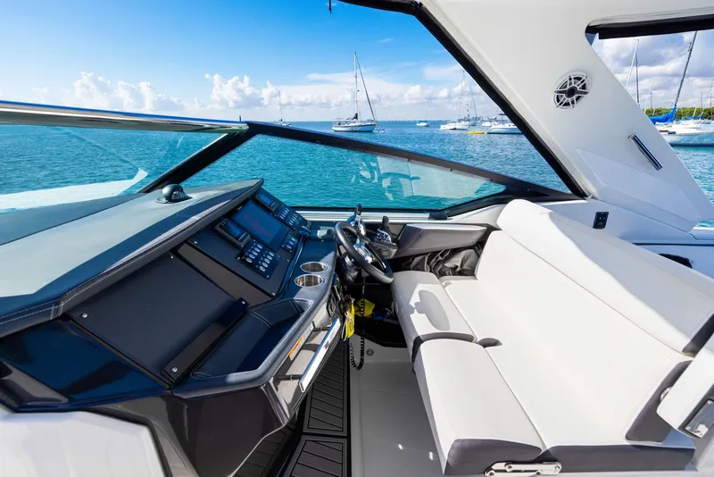 Slide: The Image of The cockpit of the 2017 Monterey 378SE Super Express features a modern dashboard and white seating. - 12