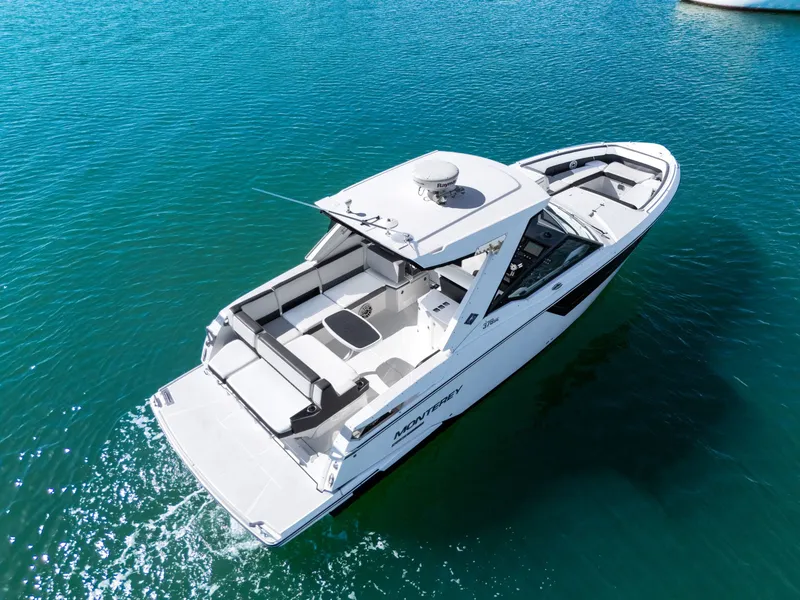 Slide: The Image of A white 2017 Monterey 378SE Super Express boat on clear water. - 8