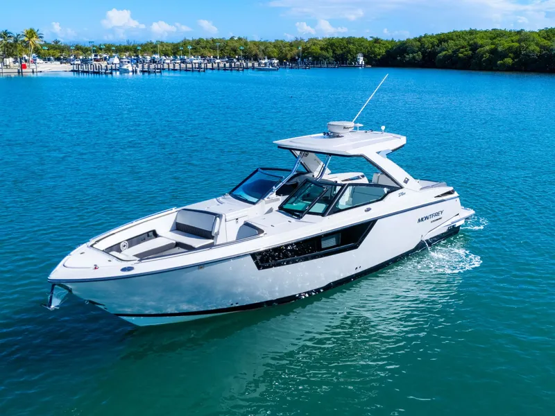 Slide: The Image of A white motorboat cruising on calm blue water, featuring a modern design and spacious deck. - 1