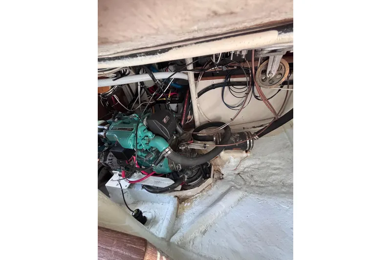 Slide: The Image of Engine compartment of a 1978 Swift 33 boat, showcasing wiring and mechanical components. - 35
