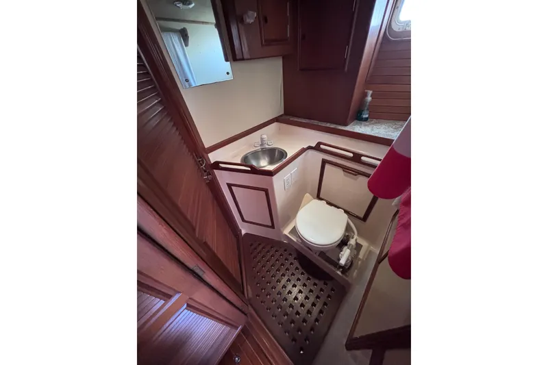 Slide: The Image of 1978 Swift 33 yacht bathroom with wooden cabinetry, sink, and toilet. - 45