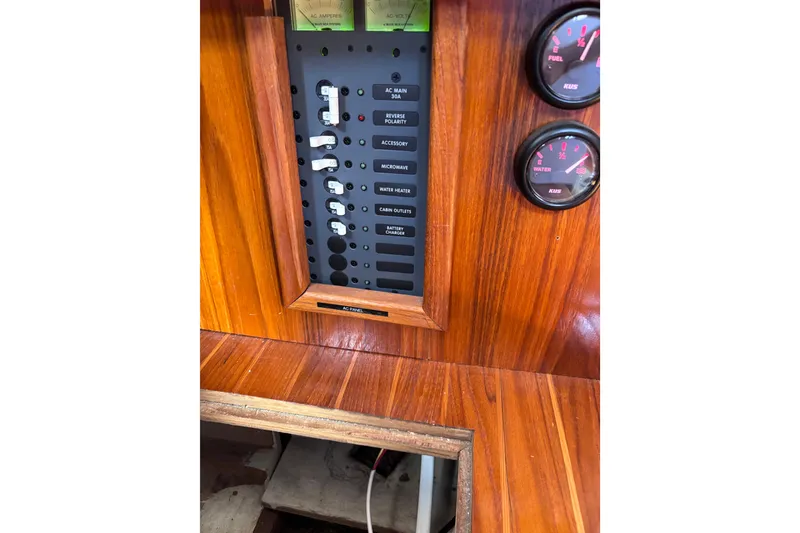 Slide: The Image of 1978 Swift 33 boat control panel with gauges and switches on wooden dashboard. - 36