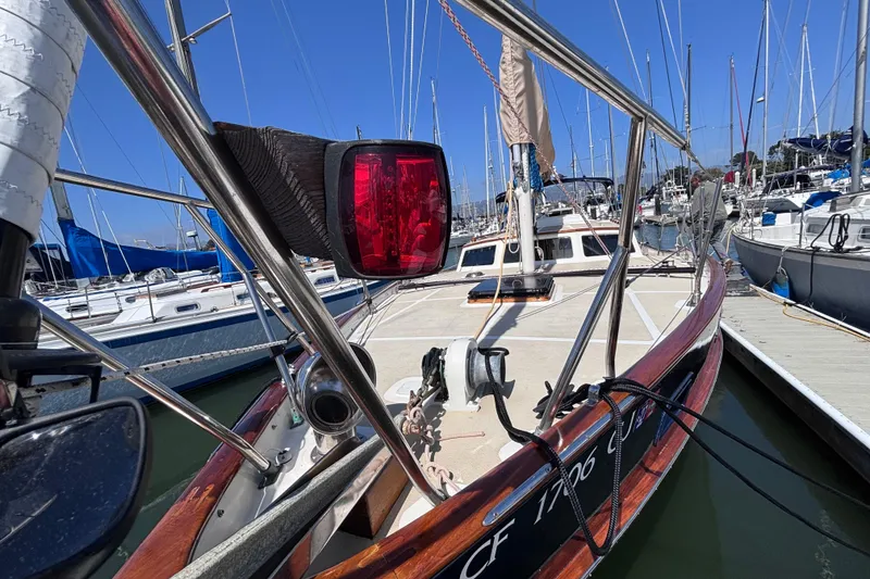 Slide: The Image of 1978 Swift 33 sailboat docked at marina, featuring deck and rigging details. - 9