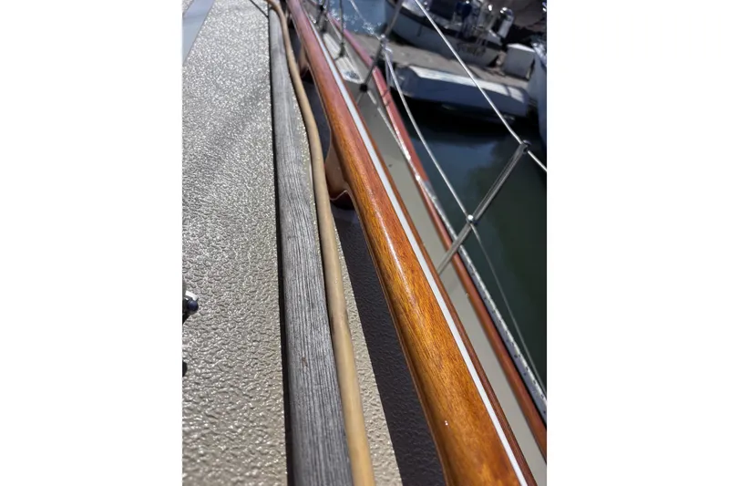 Slide: The Image of Close-up of a 1978 Swift 33 boat railing with wood and metal details. - 57