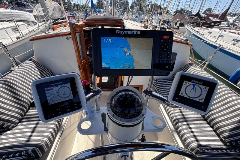Slide: The Image of Cockpit of a 1978 Swift 33 sailboat with navigation instruments and striped seating. - 15