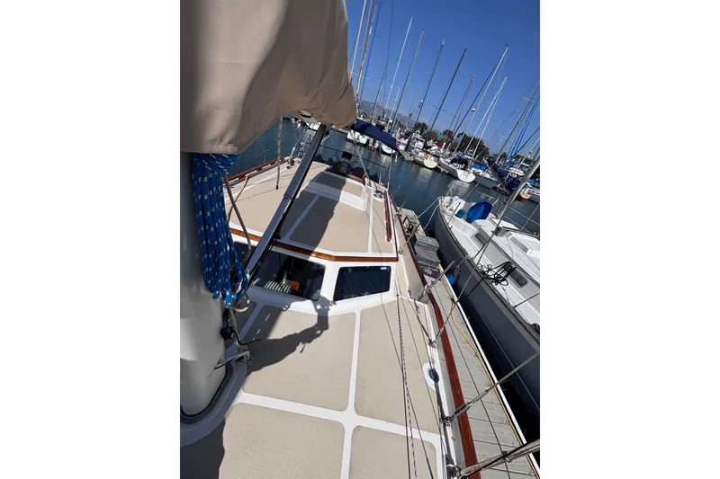 Slide: The Image of 1978 Swift 33 sailboat docked in a marina, surrounded by other boats. - 14