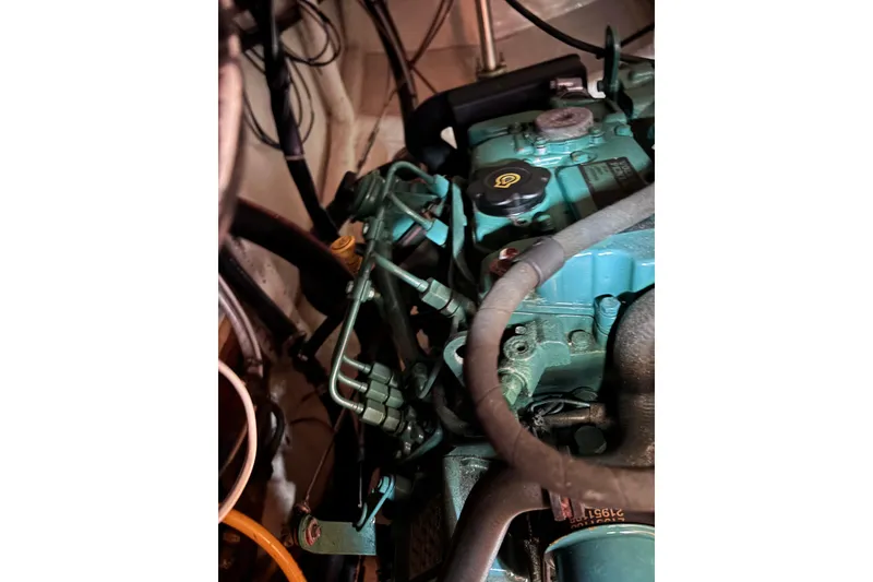 Slide: The Image of Close-up of a 1978 Swift 33 engine with visible hoses and components. - 51