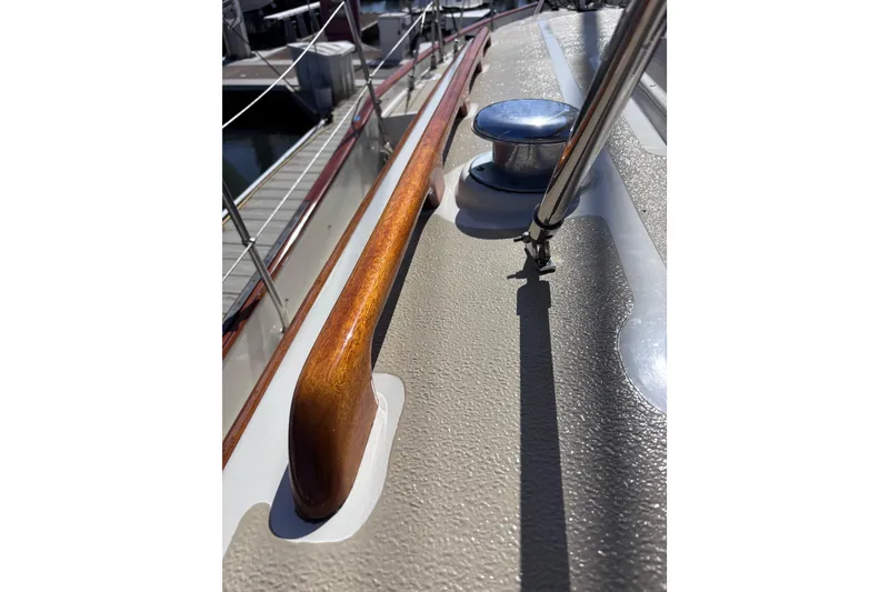 Slide: The Image of Close-up of 1978 Swift 33 sailboat deck with polished wood and metal fittings. - 55