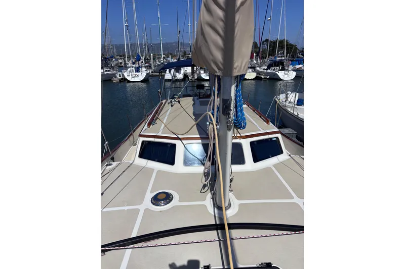 Slide: The Image of 1978 Swift 33 sailboat deck view in marina, surrounded by other boats. - 13