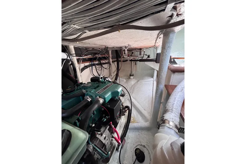 Slide: The Image of Engine compartment of a 1978 Swift 33 boat, showcasing mechanical components and wiring. - 37